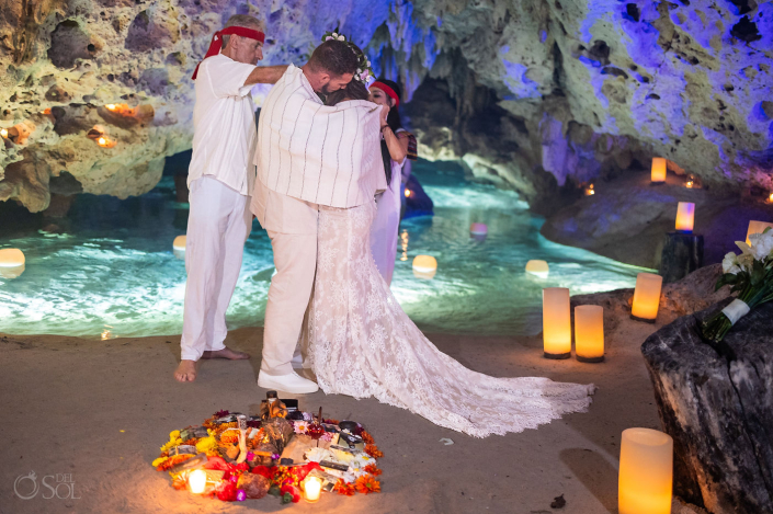 Intimate micro wedding cenote ceremony with a couple exchanging vows in the Riviera Maya