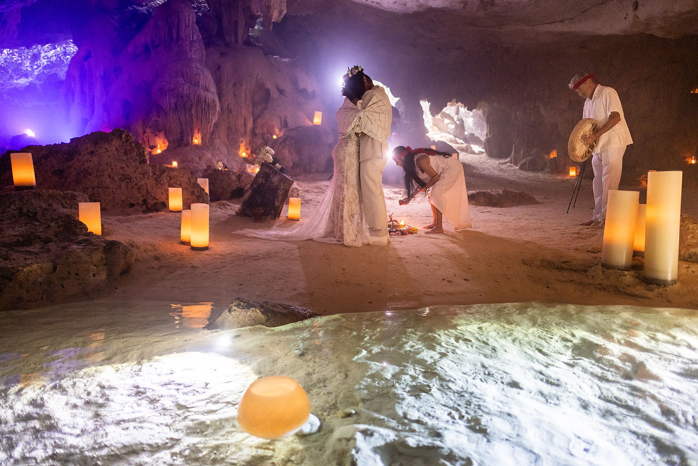 Elopement ceremony inside a sacred cenote in Mexico surrounded by natural rock formations
