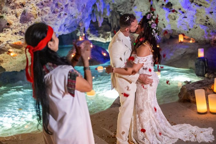 Intimate micro wedding cenote ceremony with a couple exchanging vows in the Riviera Maya