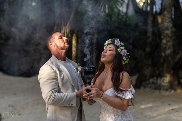 Bride and groom sharing a private moment during an intimate cenote wedding ceremony