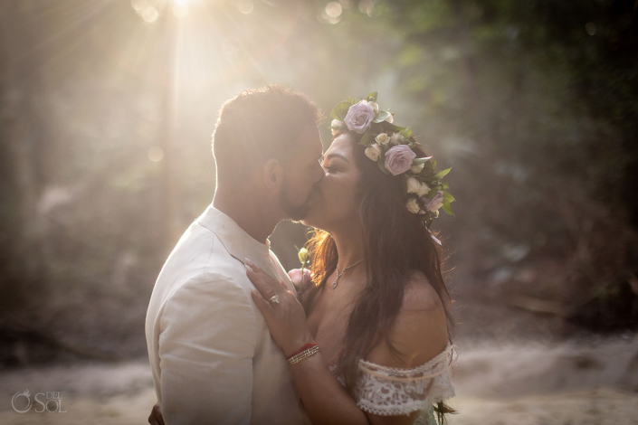 Bride and groom sharing a private moment during an intimate cenote wedding ceremony