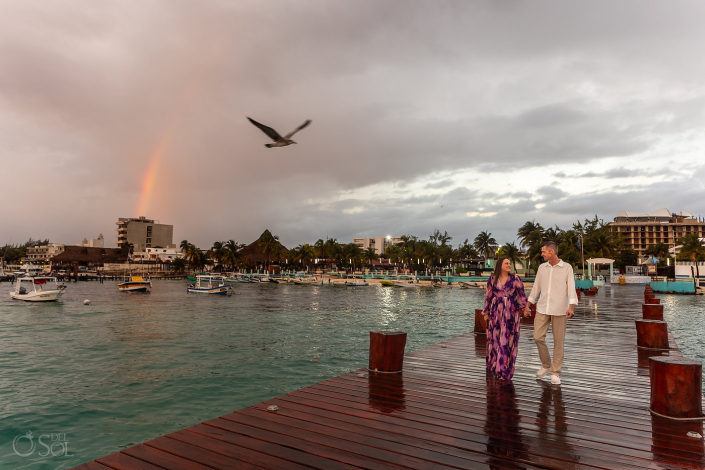 Meaningful vow renewal ceremony centered on gratitude and love with a rainbow in the background in Puerto Morelos