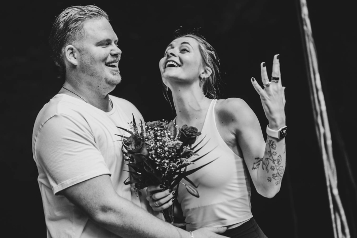 Couple posing for professional engagement photos inside a natural cenote in the Riviera Maya, Mexico