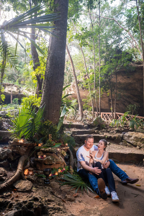Couple posing for professional engagement photos inside a natural cenote in the Riviera Maya, Mexico