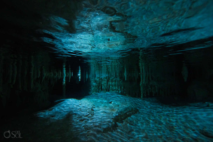 Artistic underwater cenote couple session following a trash the dress experience