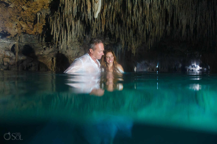 Bride and groom photographed underwater during a cenote trash the dress session