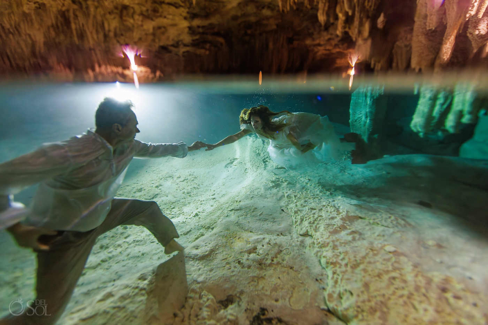 Artistic underwater trash the dress couple session in a cenote cave