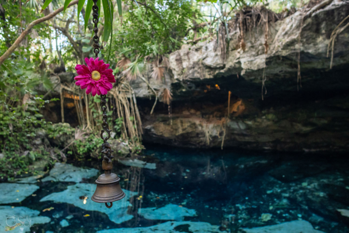 Crystal blue cenote water surrounded by jungle
