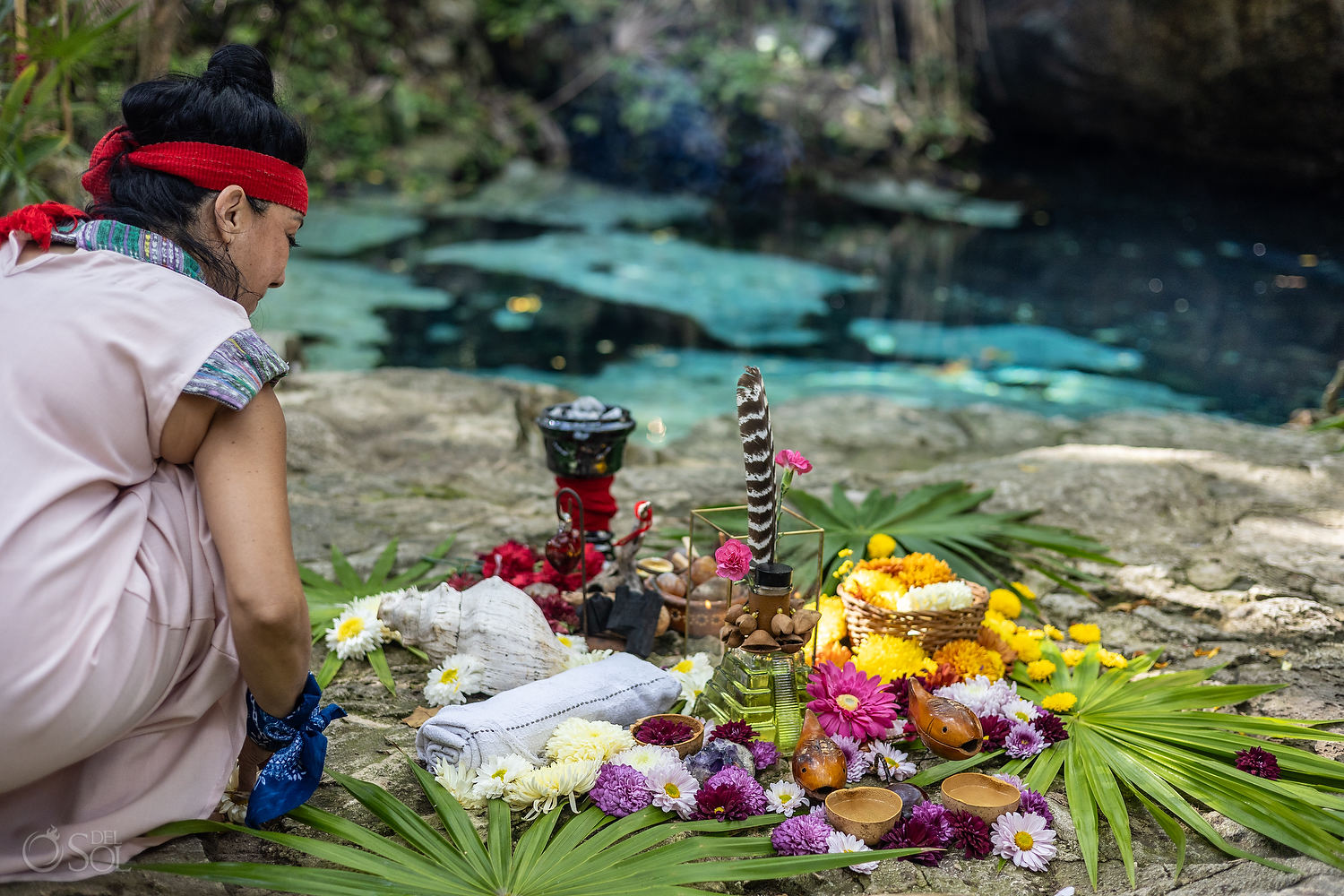 Vow ceremony altar surrounded by flowers beside the cenote