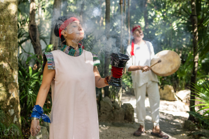 Shaman guiding an intimate vow renewal ceremony in a Mexican cenote