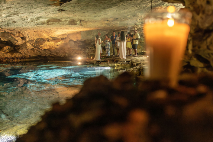 Candles glowing inside the cenote cave during the vow renewal