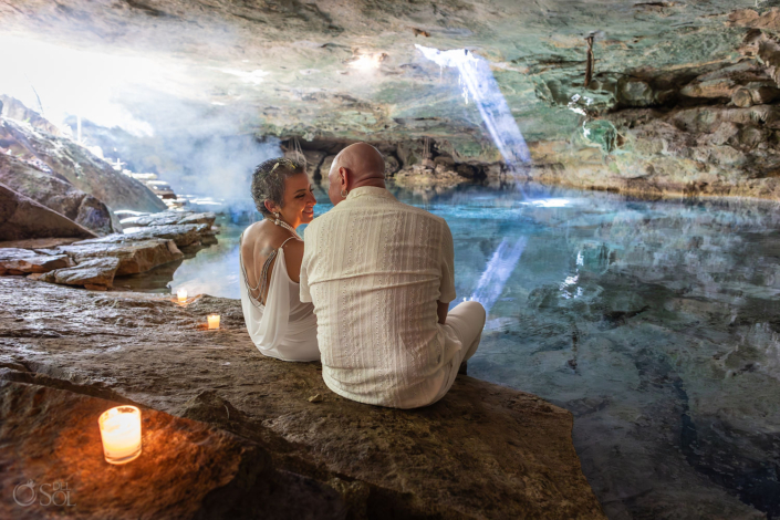 Couple reconnecting during a meaningful cenote vow renewal ceremony surrounded by water and natural light in Mexico