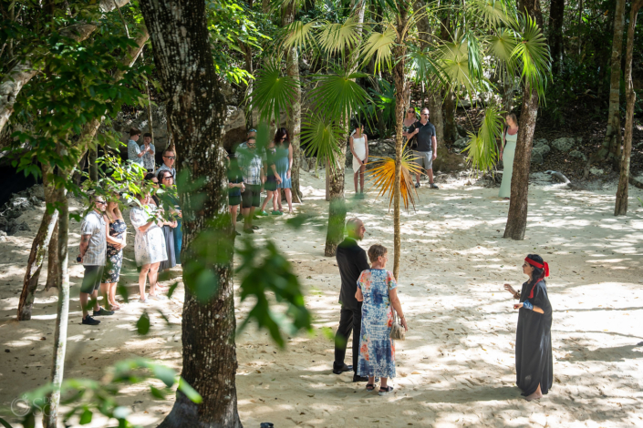 Wedding guests walking through the jungle toward the cenote ceremony.