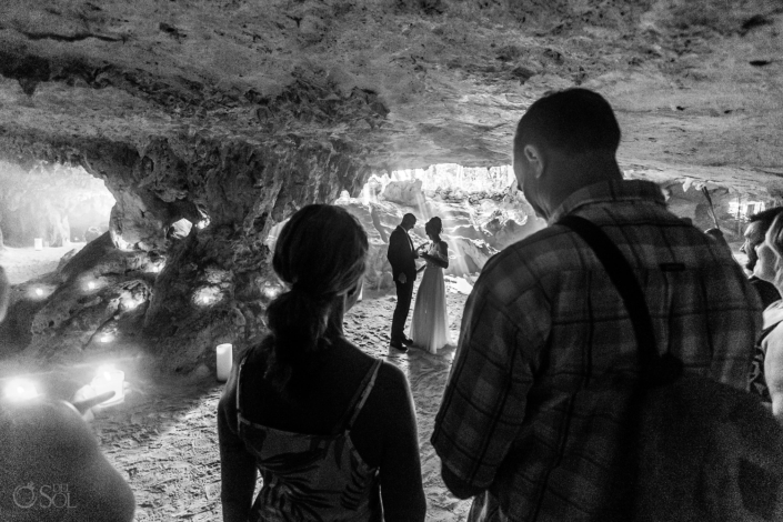 Bride and groom sharing heartfelt vows during a non-traditional wedding ceremony in a cenote.