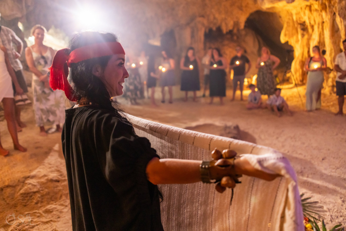 Wedding officiant leading a spiritual ceremony surrounded by family and friends.