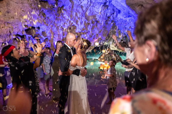 bride and groom receive a special guest flower petal blessing in their cenote ceremony