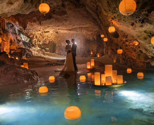 Bride and groom standing beside hundreds of candles inside a Cenote Wedding Ceremony in Mexico