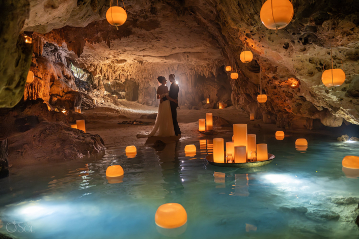 Bride and groom standing beside hundreds of candles inside a Cenote Wedding Ceremony in Mexico