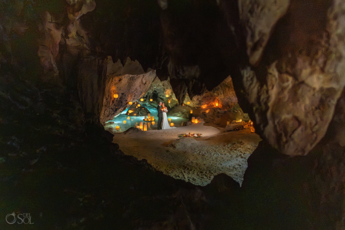 Epic cave formations with tons of candles and turquoise water in a riviera Maya cenote wedding ceremony
