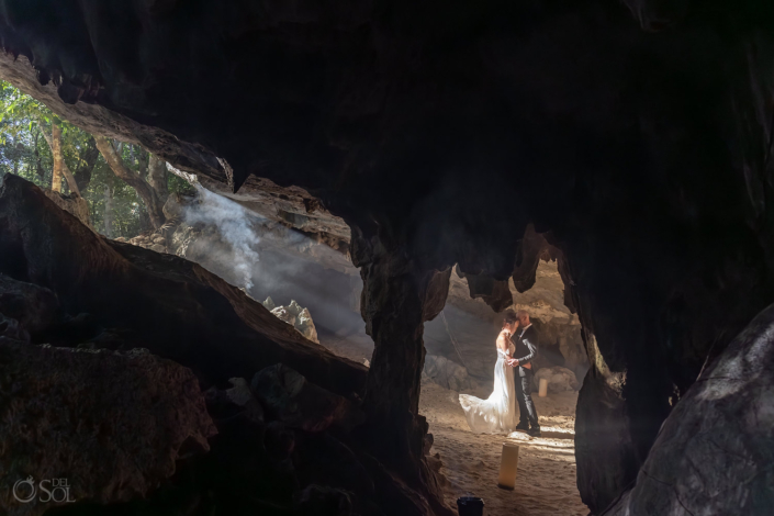 Sunlight pours into the cenote creating dramatic beams across the cave floor.