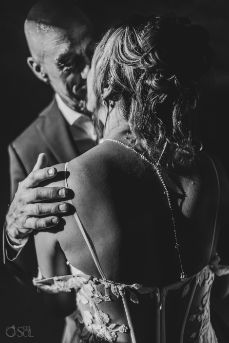 romantic embrace of a couple during their cenote ceremony