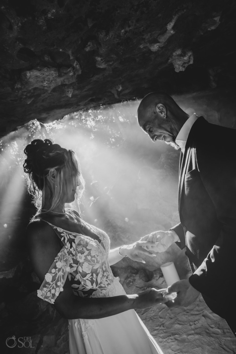 bride and groom hold hands inside a cenote wedding ceremony