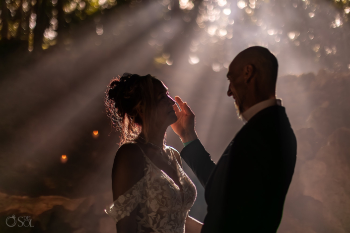 couple embrace during their intimate cenote wedding ceremony