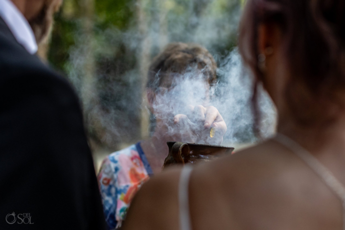 Guests placing their intentions into the ceremonial copal during the wedding.
