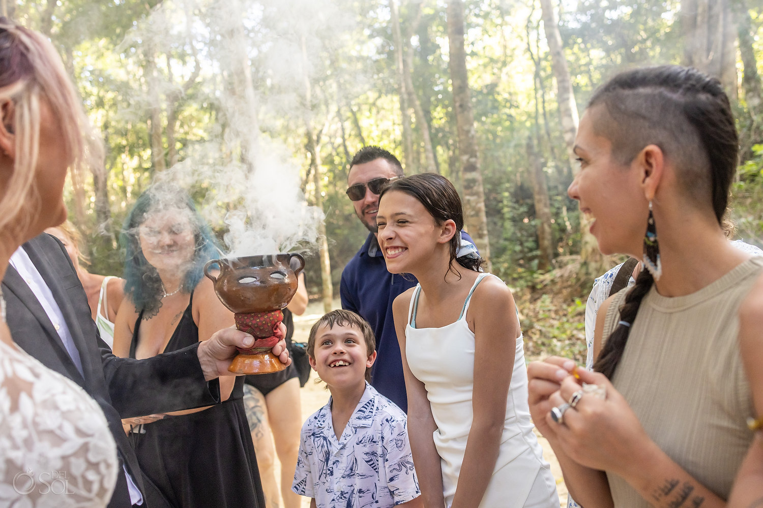 Wedding guests offering copal resin as part of a spiritual blessing ceremony.