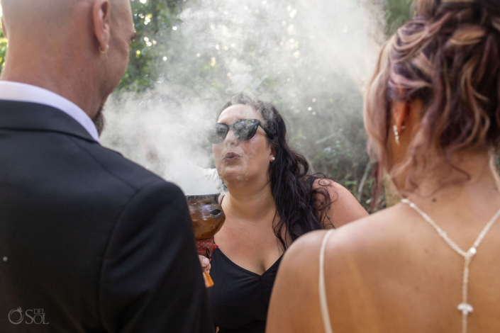 Guests raising copal incense while offering prayers and blessings for the couple.