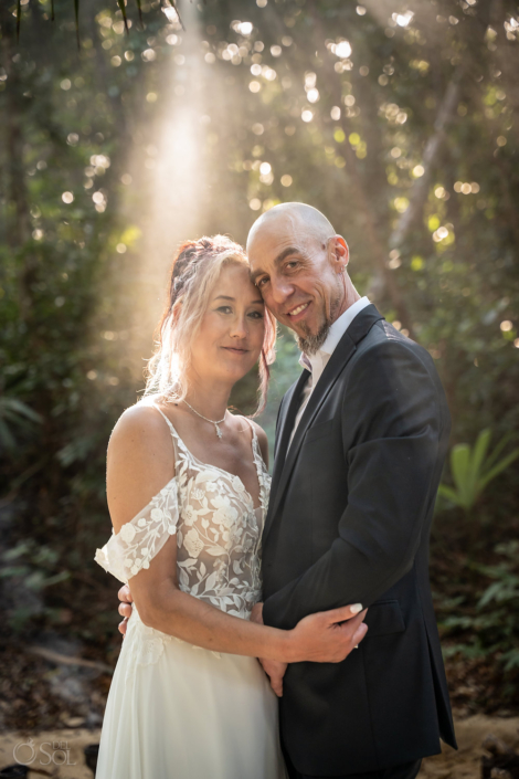 Romantic portrait of Steve and Stacey beneath the jungle canopy.