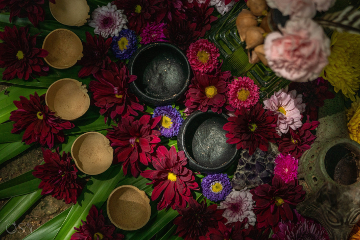 Mayan-inspired altar designed for a cenote ceremony details with flowers and cups and leaves