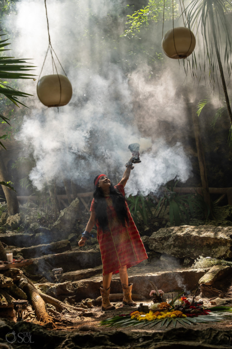 shaman cleaning the air with copal for the ceremony in the jungle cenote