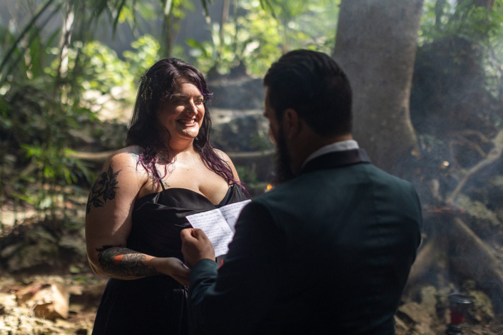 Bride and groom exchange vows during an intimate cenote wedding ceremony in Mexico.