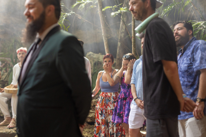 Guests crying surround the couple during a jungle cenote wedding ceremony in Mexico.