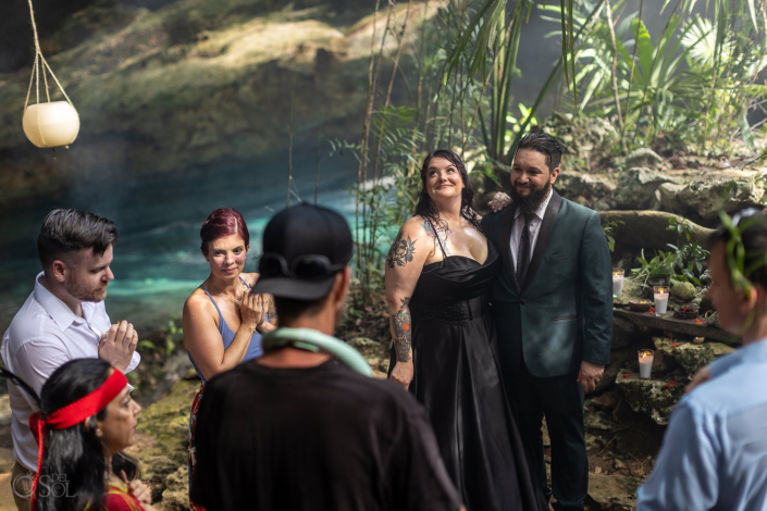 bride and groom cenote wedding in Ancient cave illuminated by natural sunlight and turquoise water