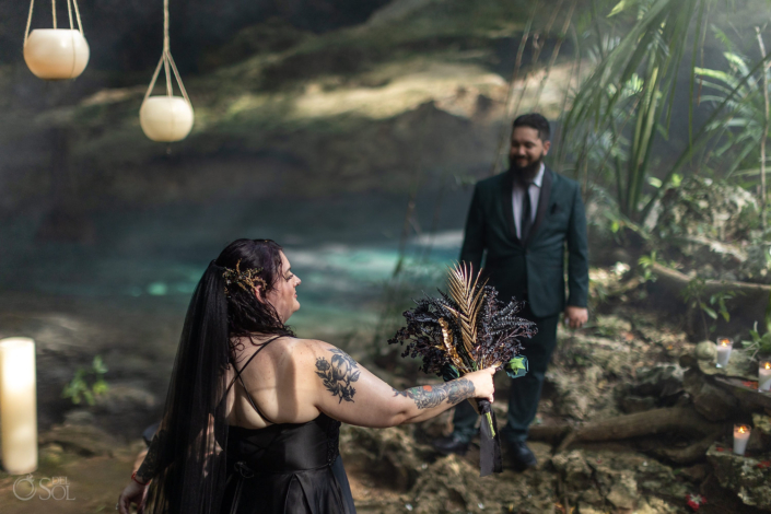 Bride in a black wedding dress in a cenote ceremony in Mexico