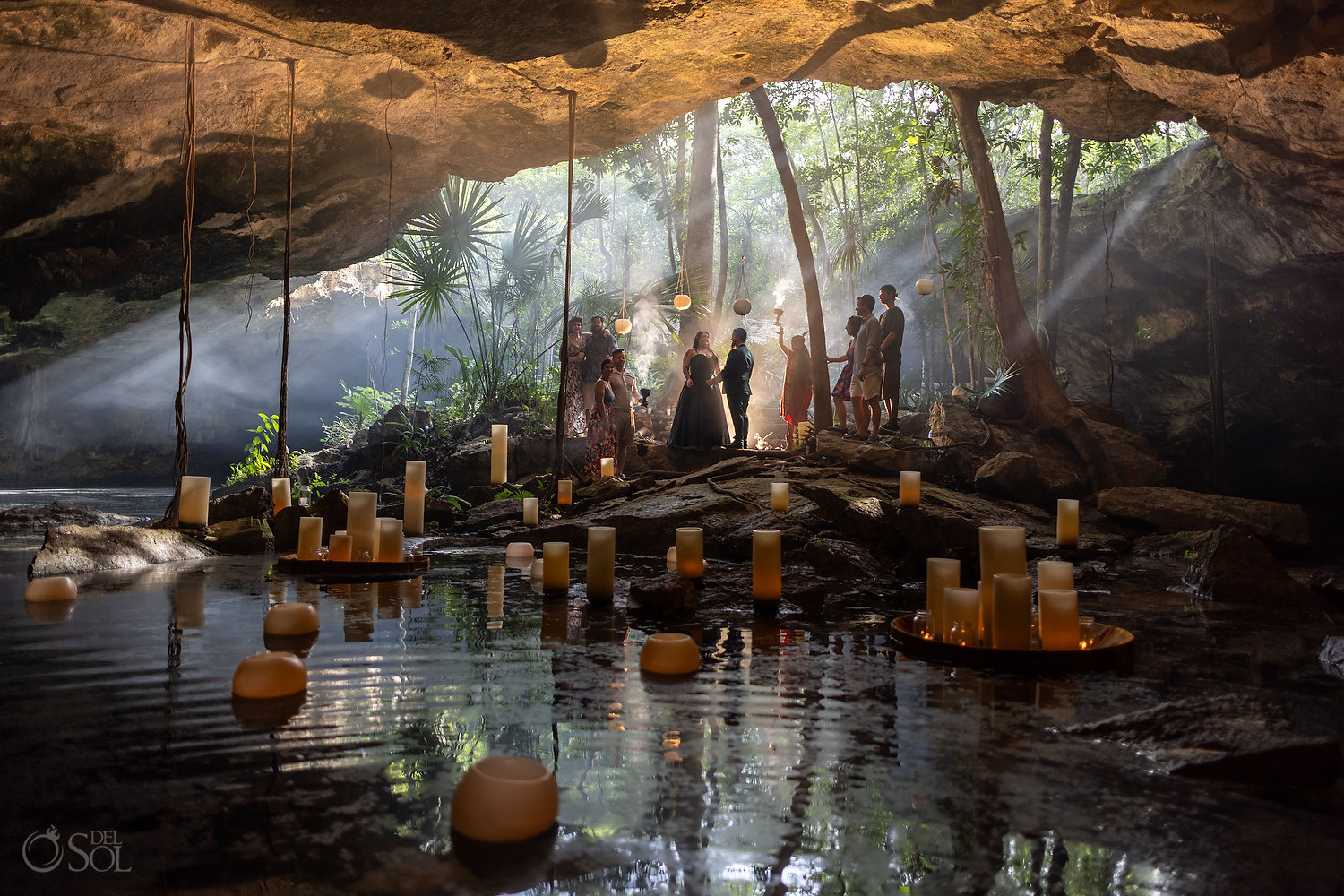 Wide-angle view of an intimate cenote wedding ceremony in Mexico with natural light, cave reflections, and cinematic atmosphere.