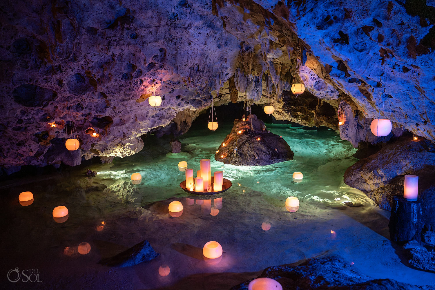 Cenote Wedding Ceremony in Mexico with floating candles and turquoise water with limestone cave formations