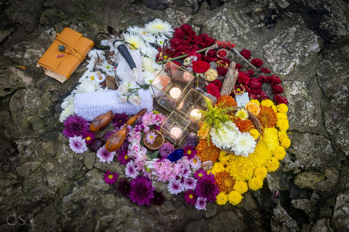 Unique spiritual wedding altar designed for an intimate cenote ceremony with flowers, seeds and ceremonial offerings