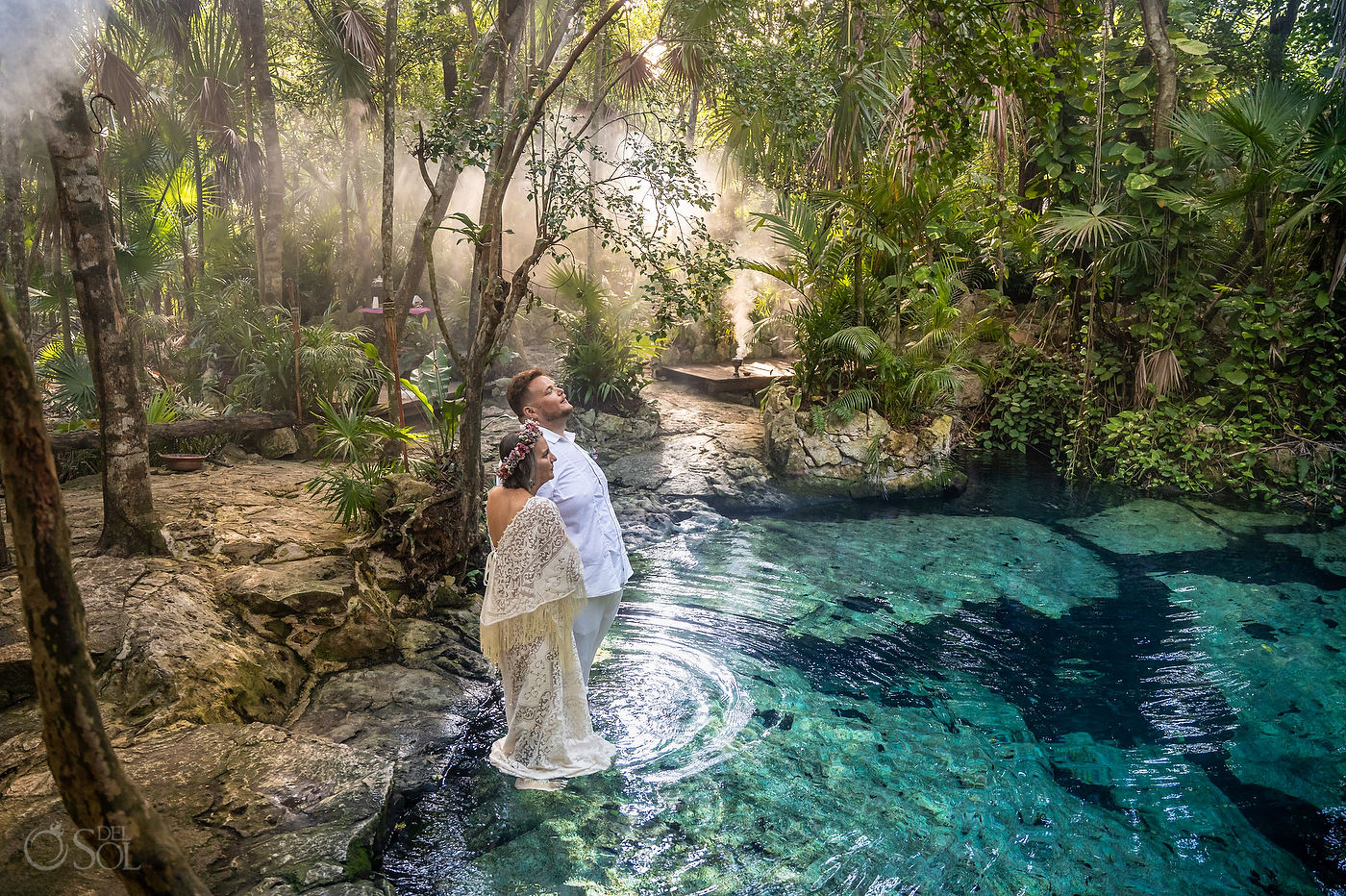 Couple standing barefoot in the cenote for a spiritual wedding during their Mexico cenote ceremony