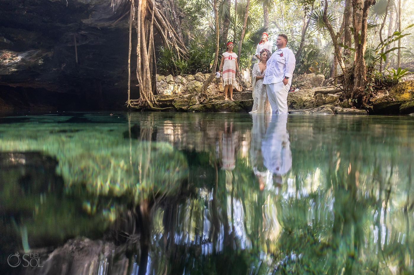 Private cenote wedding ceremony beside turquoise water in the Riviera Maya jungle
