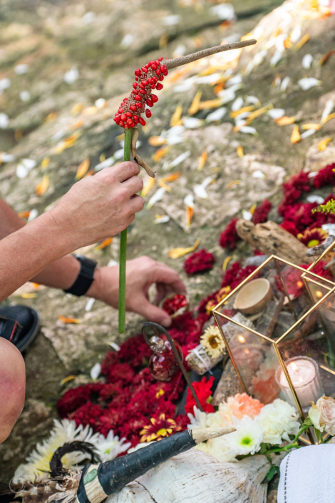 Red seeds held during a symbolic 50-seed wedding ritual in a Mexican cenote