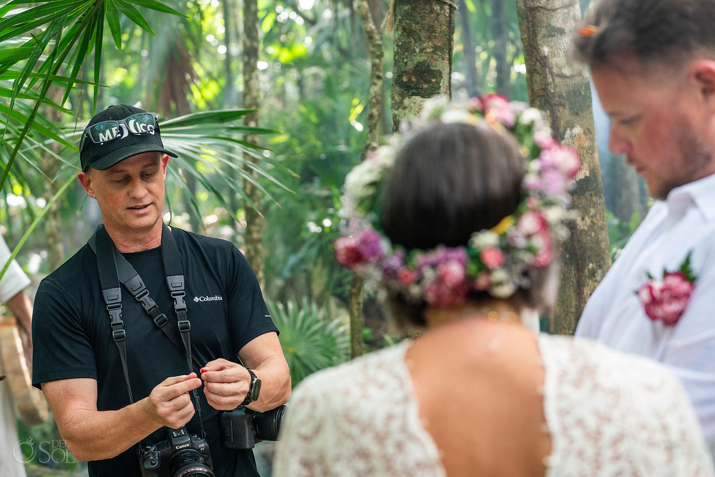 photographer matt adcock explaining the process of the symbolic red seeds to be placed around the cenote