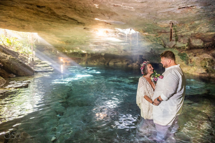 Newlyweds standing inside one of Mexico’s natural cathedral cenotes